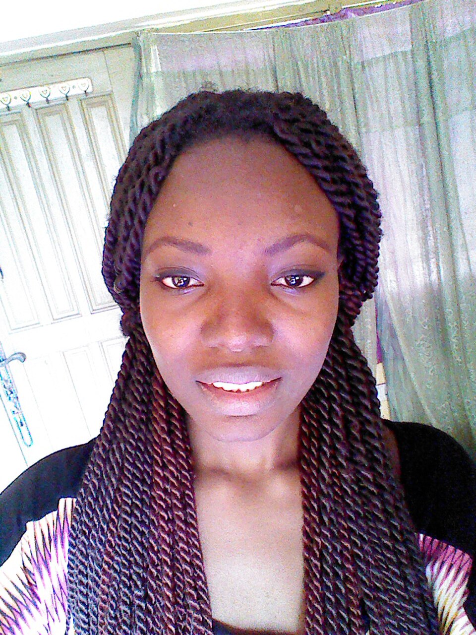 Close-up portrait of a Black woman with long Senegalese twists